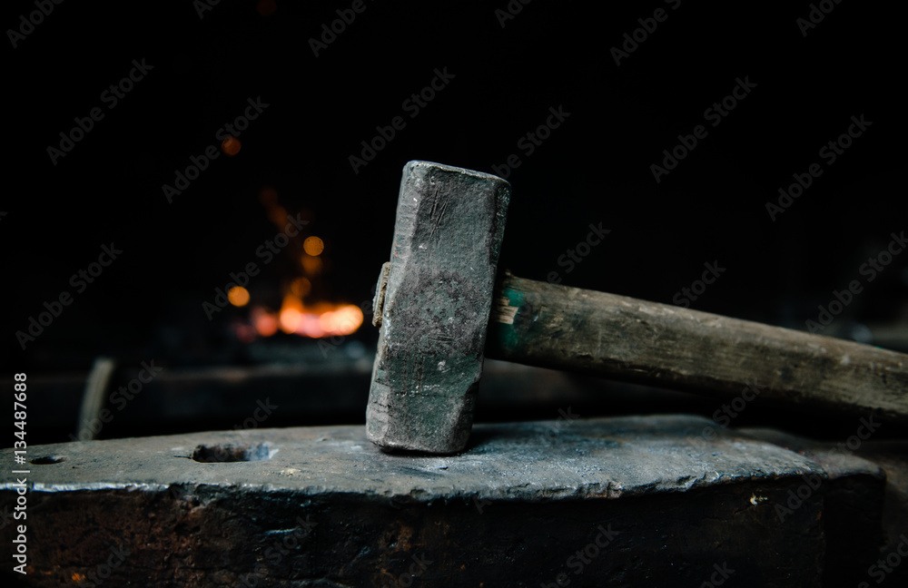 blacksmith hammer on the anvil against the background of fire Stock Photo |  Adobe Stock
