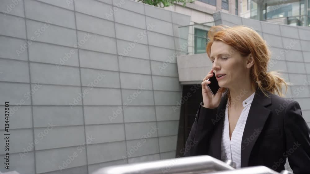Businesswoman using smart phone and on the move Businesswoman using smart phone and on the move