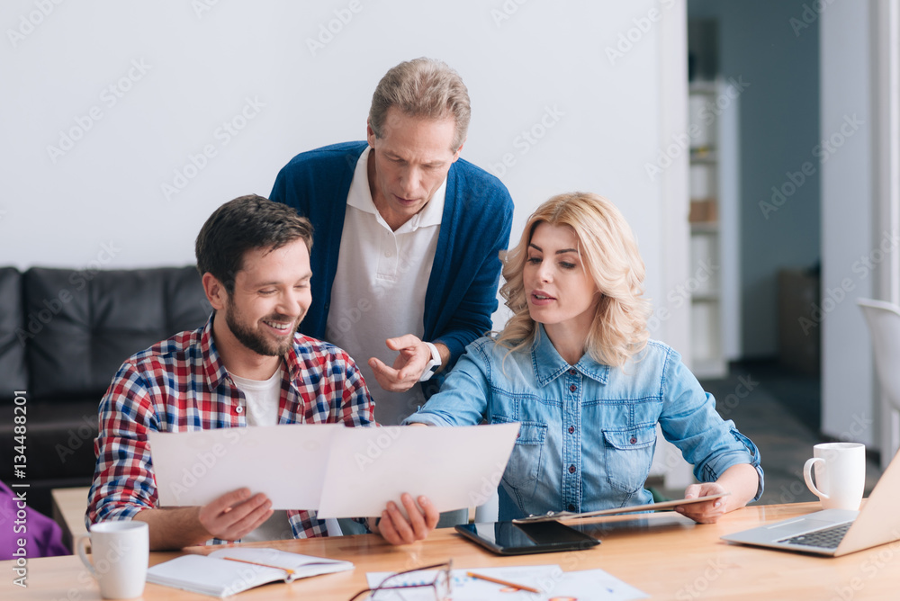 Fototapeta premium Serious pretty woman looking at the pieces of paper