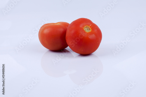 Ripe fresh tomato isolated on white.