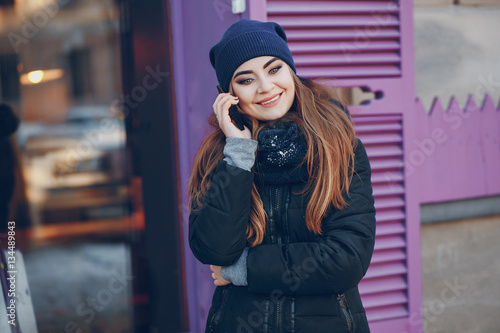 girl walking in a winter city © hetmanstock2