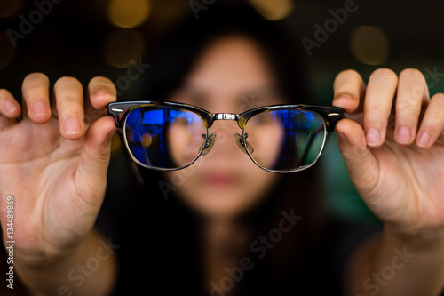 woman holding glassed with blurry background
