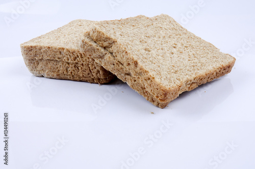 Loaf of wholemeal bread on white background