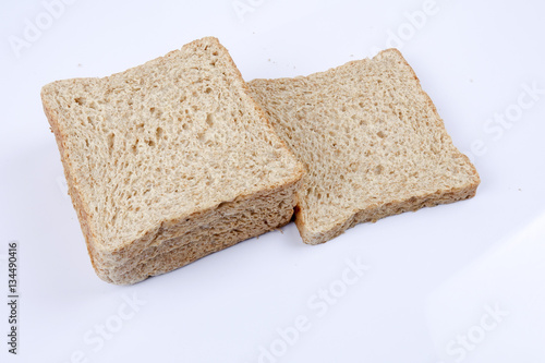 Loaf of wholemeal bread on white background
