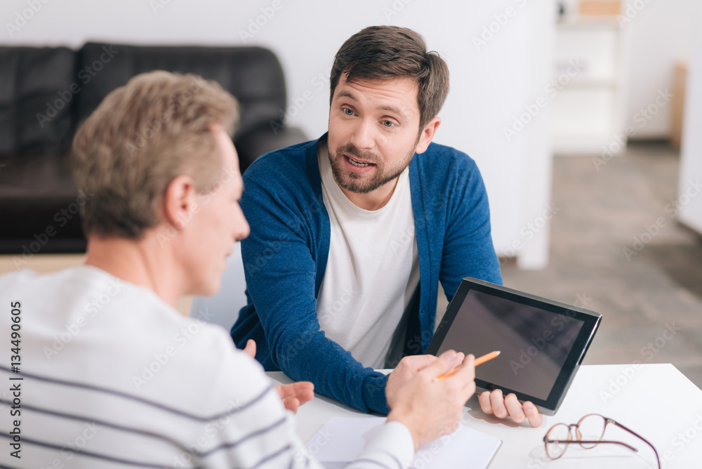 Nice bearded man using a tablet Nice bearded man using a tablet