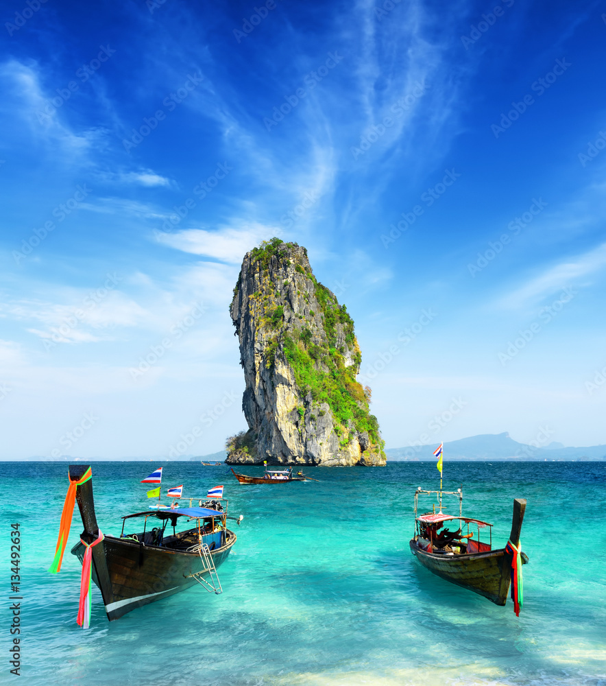 Fototapeta premium Two boats and a rock in the sea. Krabi province