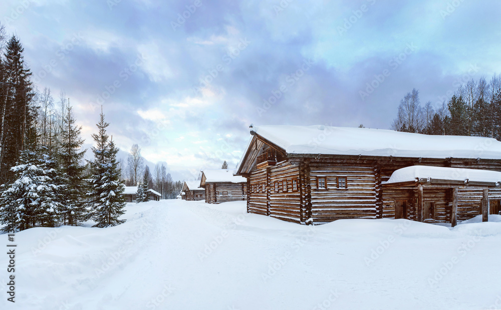 Old Village Log Houses in museum Small Karelians near Arkhangelsk, Russia. Winter sunset time. Old Village Log Houses in museum Small Karelians near Arkhangelsk, Russia. Winter sunset time.