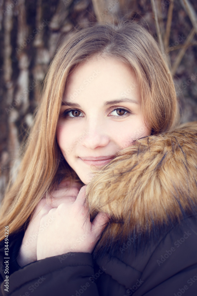 Portrait of Young smiling girl with long hair in winter park Portrait of Young smiling girl with long hair in winter park