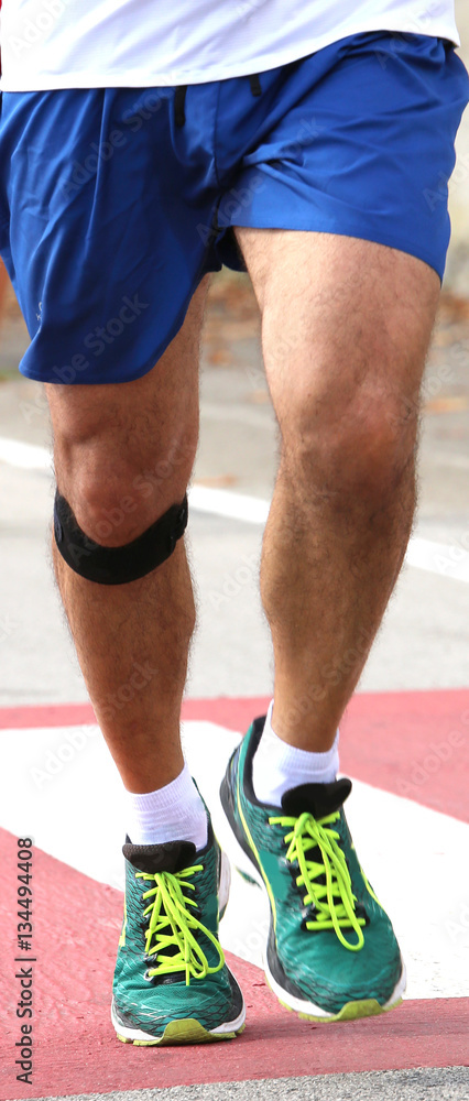 Fototapeta premium athletic runner with elastic band at the knee