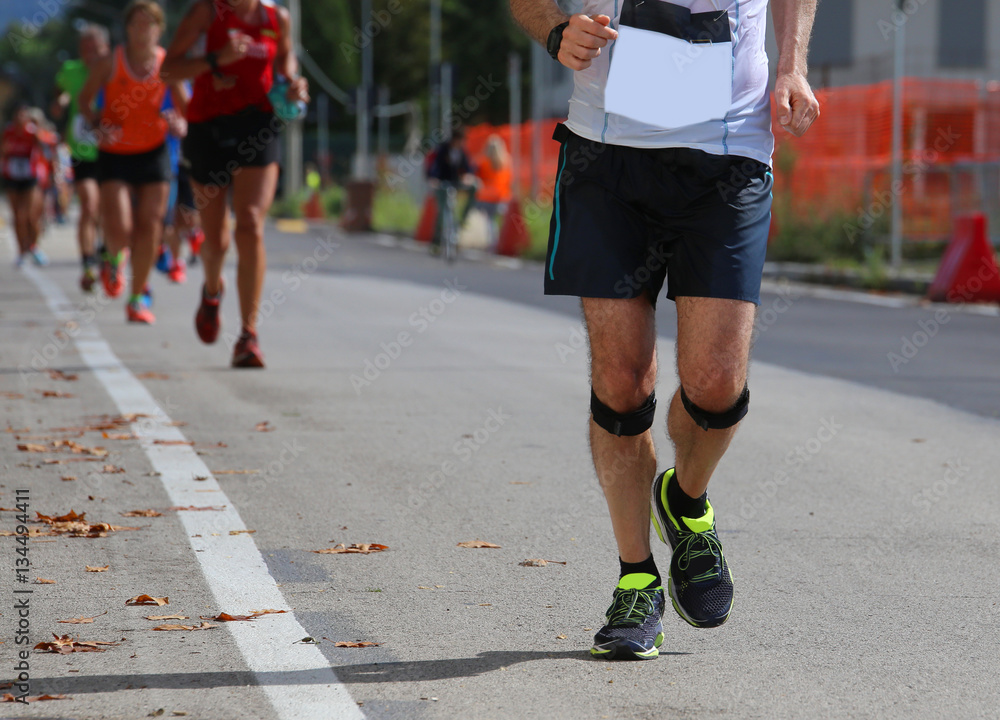 athletic runner with elastic band at the knee running fast durin athletic runner with elastic band at the knee running fast durin