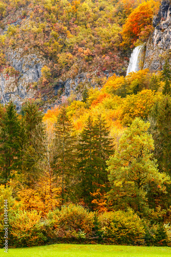 Periodic incredible waterfall in the autumn mountains