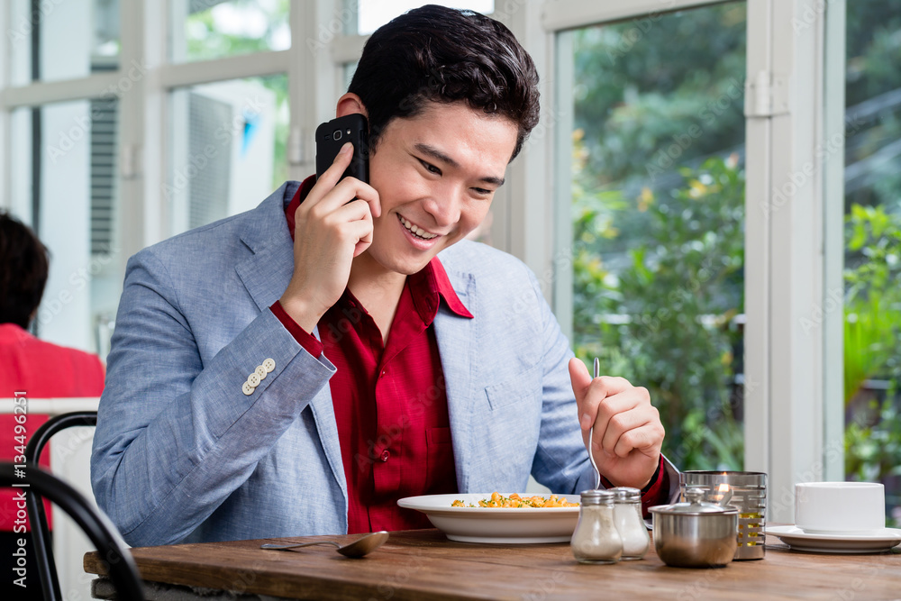 Handsome young businessman talking on a mobile Handsome young businessman talking on a mobile