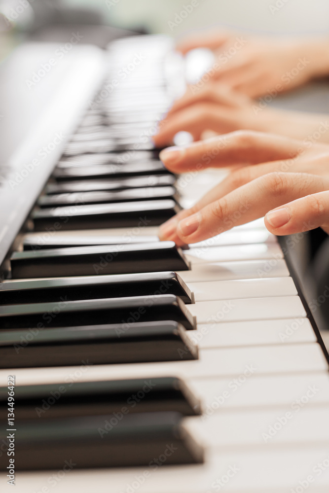Obraz premium Closeup of hands playing piano. Music and hobby concept