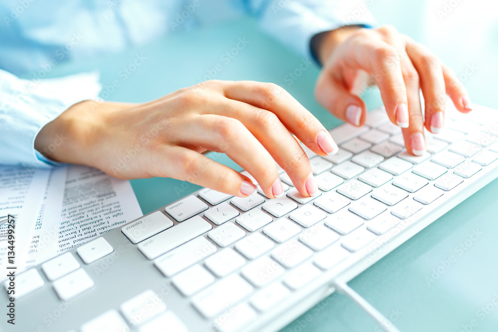 Woman office worker typing on the keyboard Woman office worker typing on the keyboard
