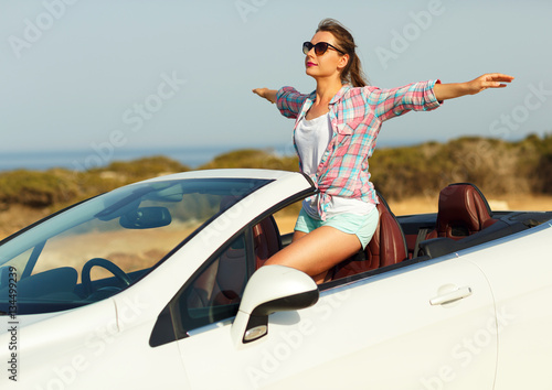 Freedom - happy free woman in cabriolet cheering joyful with arm