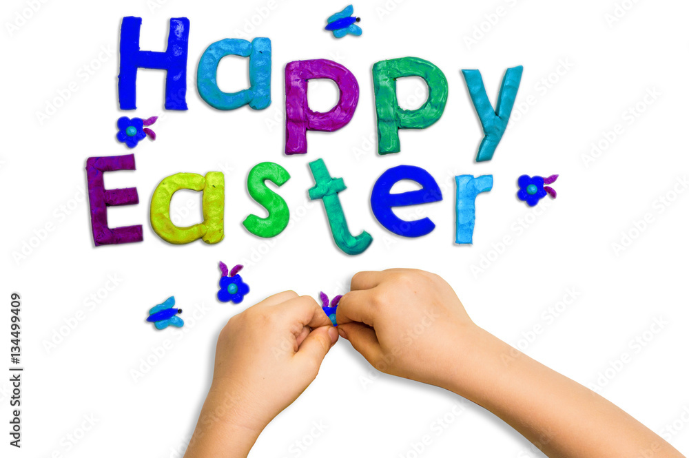 children's hands and words fashioned from clay Happy Easter on a white background children's hands and words fashioned from clay Happy Easter on a white background