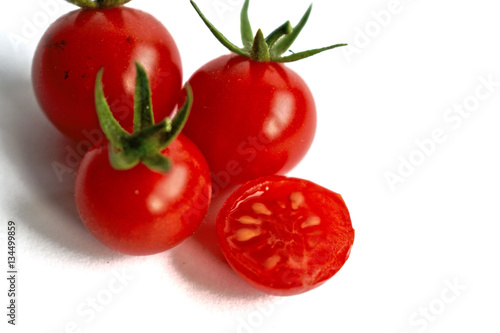 Closeup of ripe cherry tomatoes on a white background