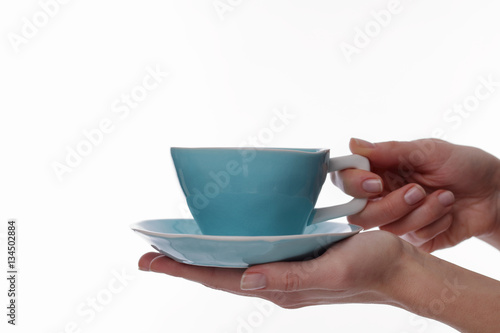 Woman holding tea cup on white background close up on hands. Winter days, Warmth concept