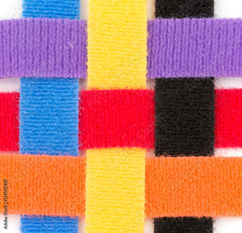 Foto Colorful velcro strips braided together in over one, under one sequence, on whit