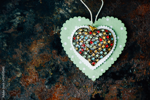 Beautiful heart made from metal and presicous stounes on black photo