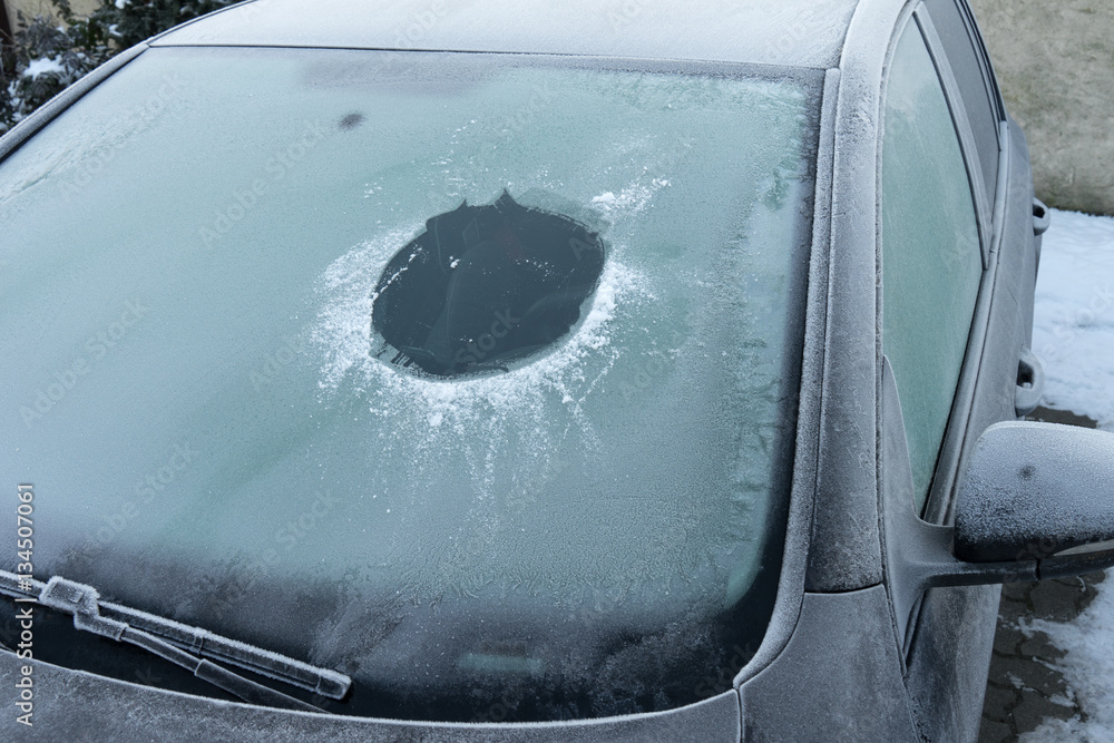 Winter / zugefrorene Frontscheibe mit Guckloch von einem Auto im Winter  Stock Photo