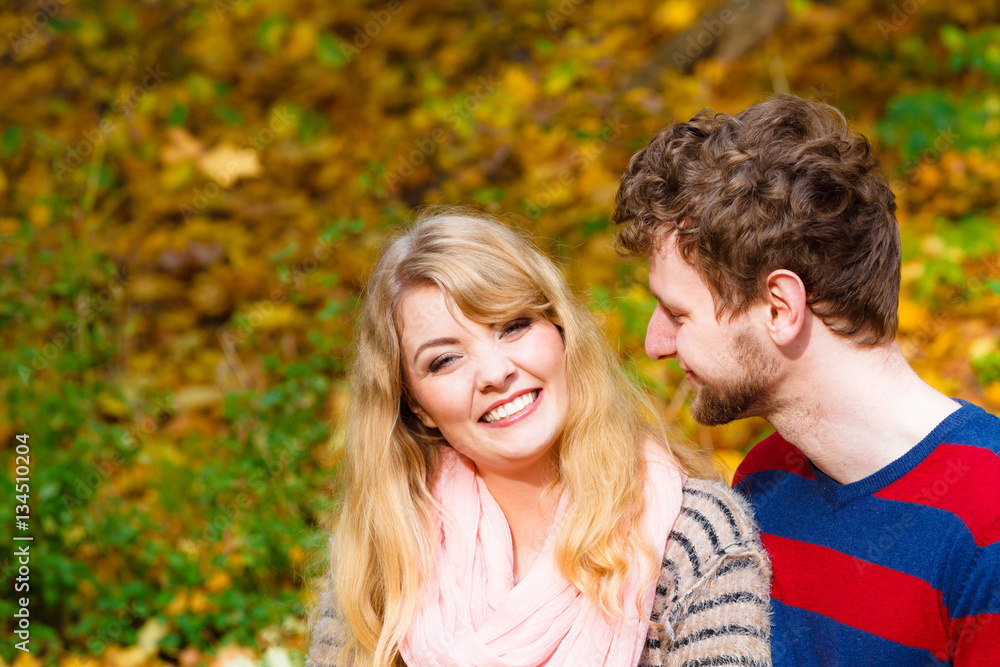 Lovers couple in autumn park on bench Lovers couple in autumn park on bench