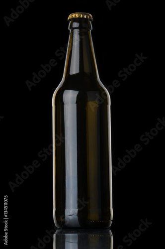 Beer bottle with cork on black background