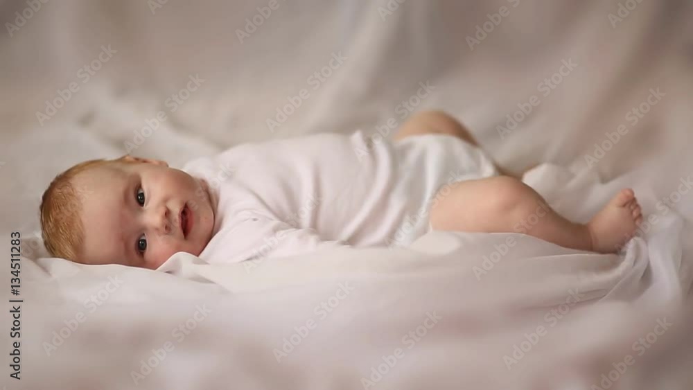 Portrait of four month old baby lying on his back on white background Portrait of four month old baby lying on his back on white background