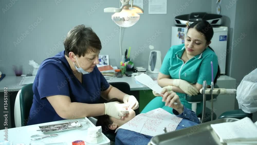 Orthodontic Treatment. Bite correction. Orthodontist at work. The boy