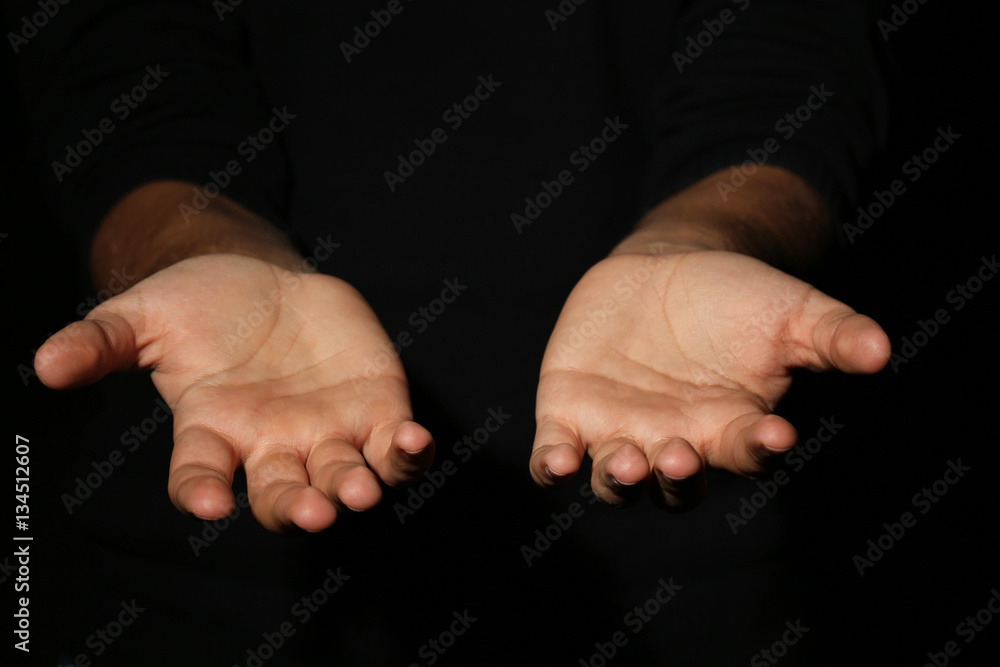 Male hands on a black background Male hands on a black background
