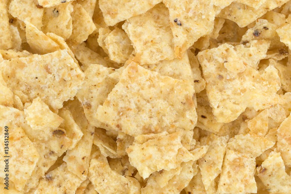 Close view of broken tortilla chips. Close view of broken tortilla chips.