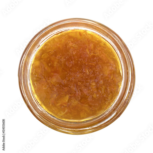 Sugar free orange marmalade in an opened jar isolated on a white background.