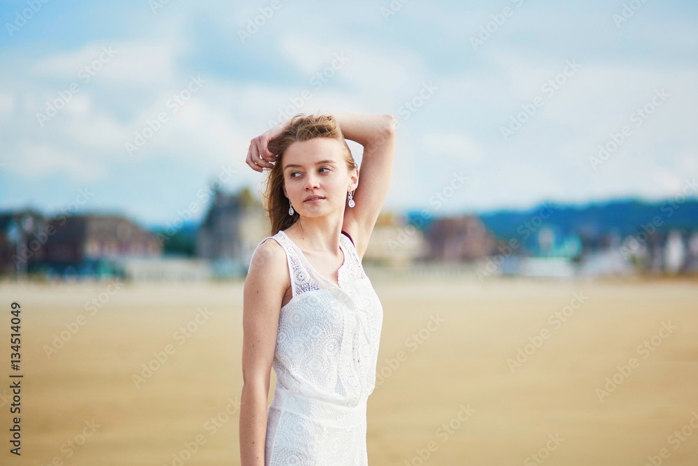 Beautiful young woman enjoying sun on a sand beach Beautiful young woman enjoying sun on a sand beach