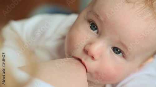 Mother with blond hair breastfeeding