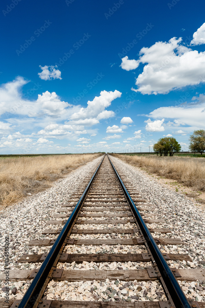 Rail Road and Clouds in a blue Sky in New Mexico