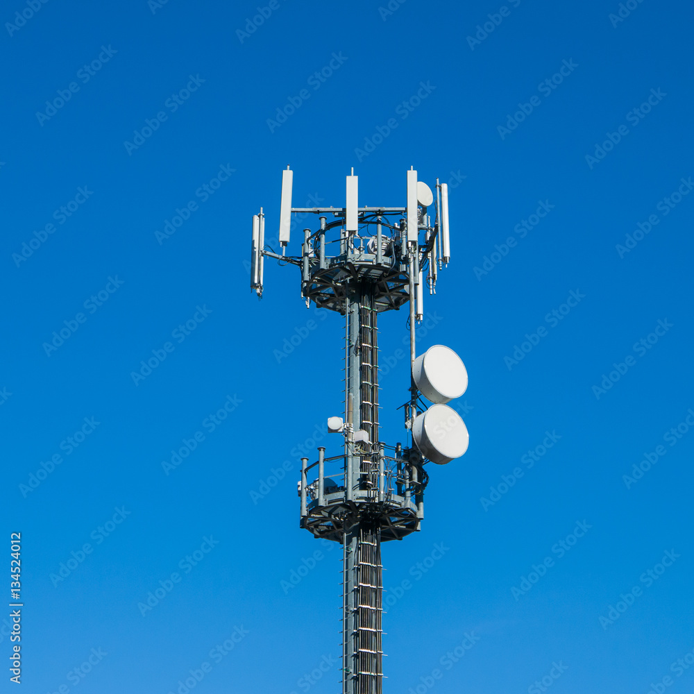 Communication tower against crystal clear blue sky background