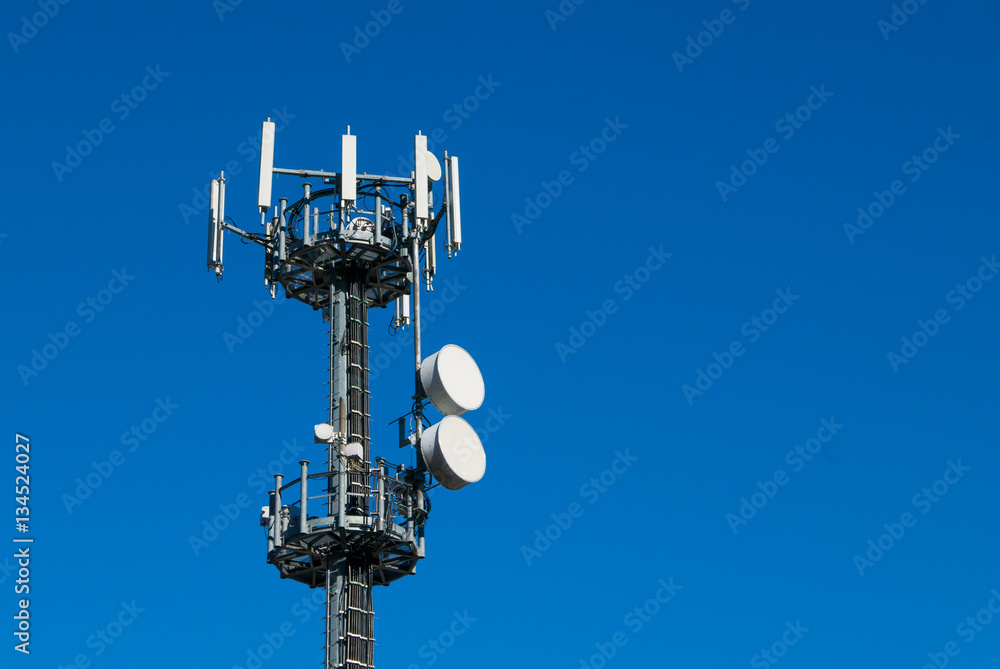 Communication tower against crystal clear blue sky background
