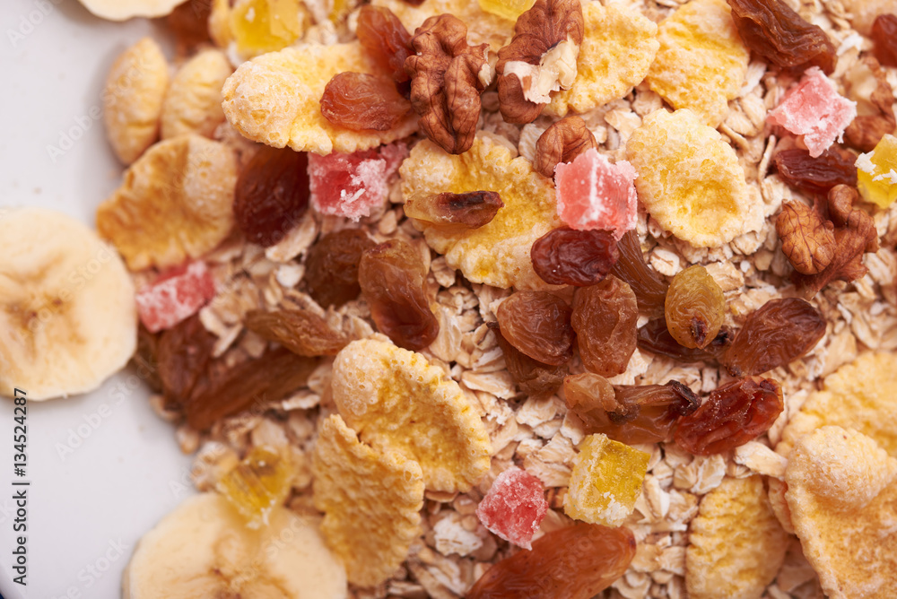 flakes with dried fruit, granola on the plate flakes with dried fruit, granola on the plate
