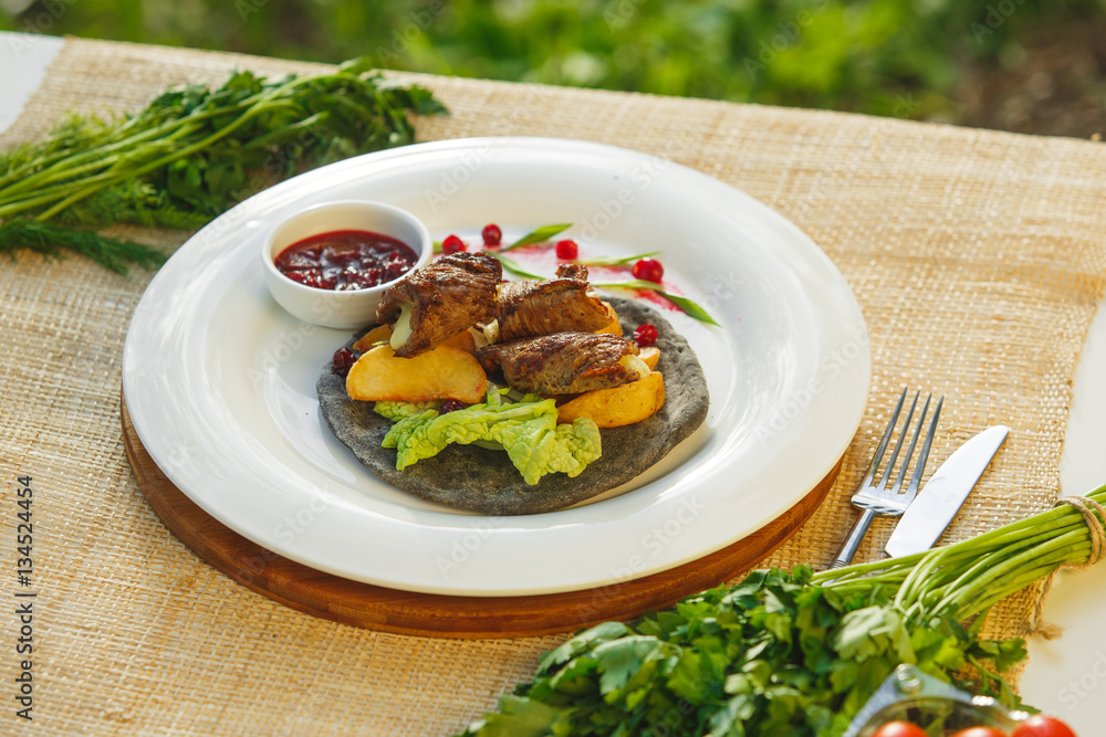 meat with greens on a cake the background of nature. Picnic meat with greens on a cake the background of nature. Picnic