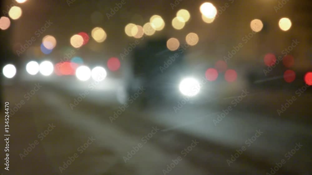 Cars in Night street with bokeh lights in the snowstorm. Cars in Night street with bokeh lights in the snowstorm.
