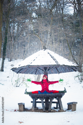 Wallpaper Mural happy young woman doing yoga  in snow park Torontodigital.ca