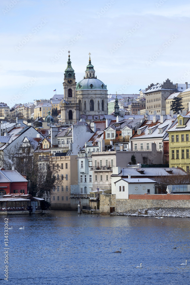 Snowy freeze Prague Lesser Town with St. Nicholas' above River Vltava, Czech republic 