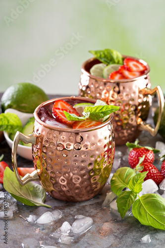 Moscow mule cocktail with lime and strawberry