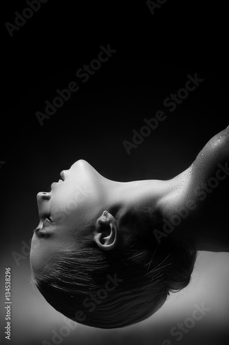 sensual aroused woman on black background with copyspace monochrome