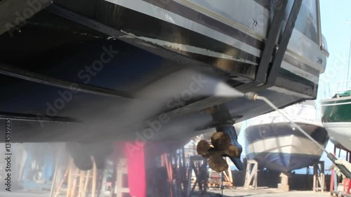Boat cleaning operation with high pressure washer after the hauling.