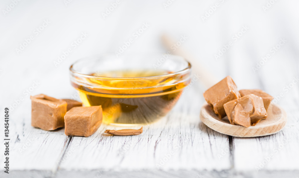 Caramel Syrup on wooden background (selective focus) Caramel Syrup on wooden background (selective focus)