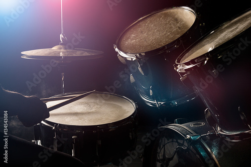 The man is playing drumset