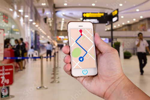 Man is holding mobile phone with map gps navigation.
