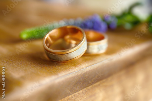 Golden wedding rings on wooden background