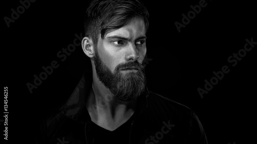 Print op canvas Black and white portrait of bearded handsome man in a pensive mo